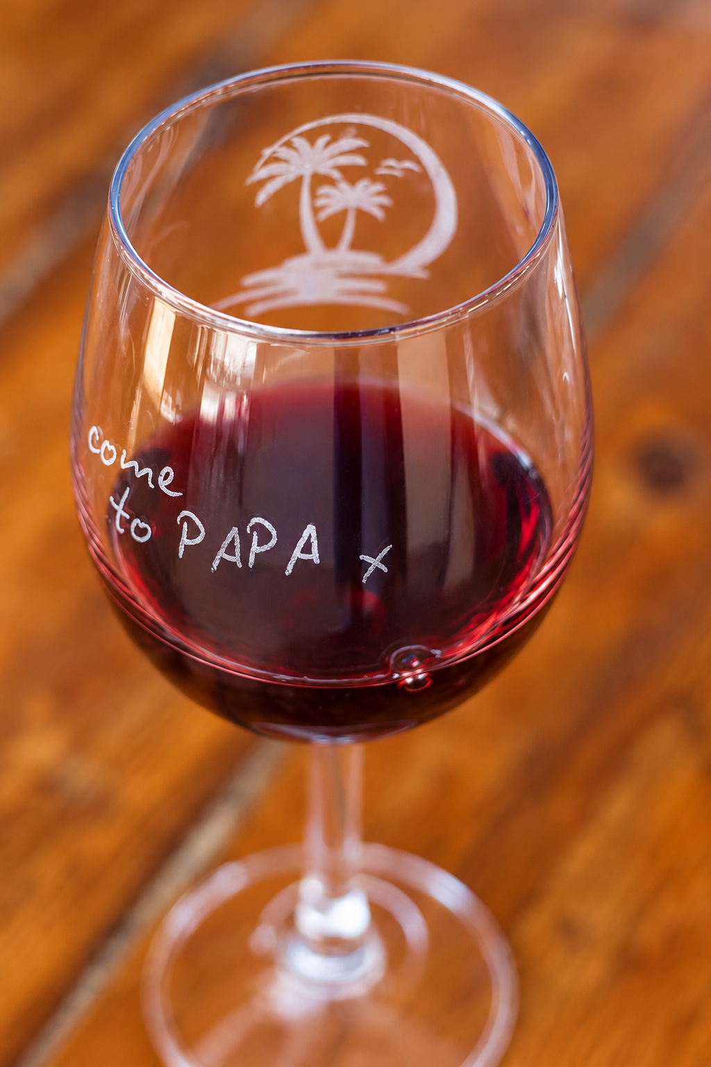 Engraved lettering detail for PAPAS on a wooden table