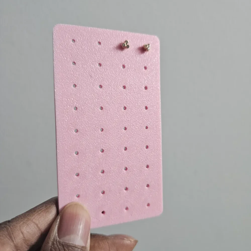 Pink travel earring holder with 36 holes for 18 pairs of stud earrings
