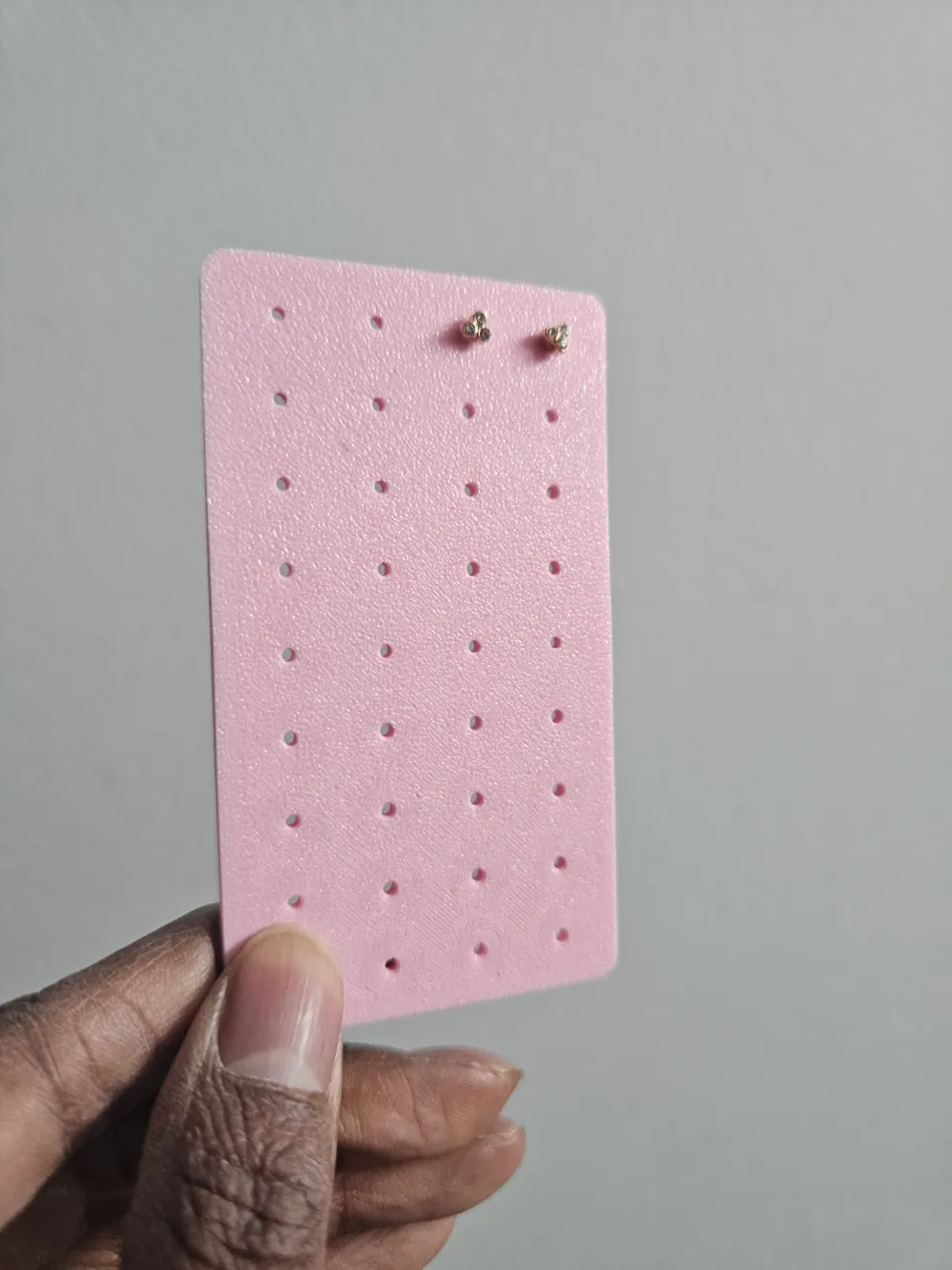 Pink travel earring holder with 36 holes for 18 pairs of stud earrings